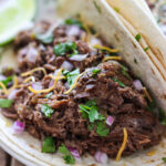 These slow cooker shredded beef tacos are summer slow cooking at its best! Pair it with your favorite toppings.