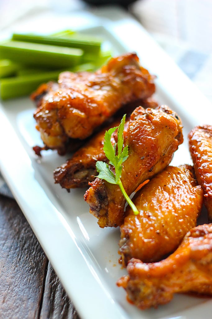 Buffalo Chicken Wings Turn wings over and brush with mixture. Bake 5 to 10 more minutes until the meat of the wings is no longer pink. Serve with blue cheese dressing and celery sticks.