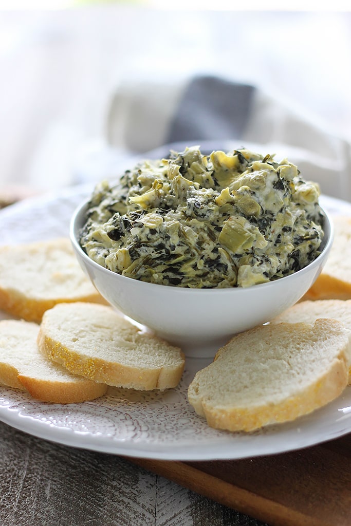 Seriously easy and seriously yummy. This homemade slow cooker spinach and artichoke dip feeds a crowd of ten!