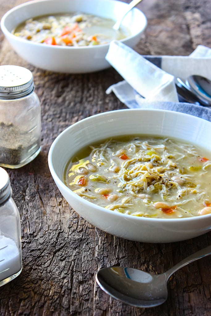 A slow cooker white chicken chili with tender chicken and beans simmered in a thick broth with green chilies, onions and celery. Pair it with your favorite toppings.